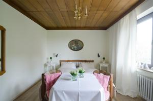 a dining room with a white table and chairs at Schwarzberghof in Dachau +26 photos