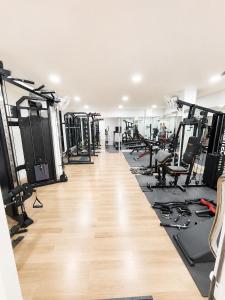 a gym with a lot of treadmills and machines at เจฮอนโด อพาร์ตเมนต์ in Ban Si Than