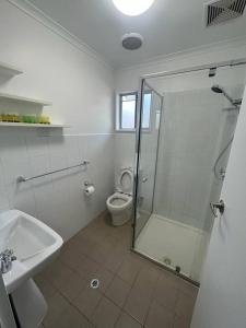 a bathroom with a shower and a toilet and a sink at Comara Jindabyne Unit 2 in Jindabyne