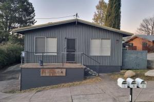 a small house with two parking meters in front of it at Comara Jindabyne Unit 2 in Jindabyne