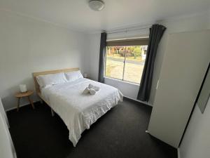 a bedroom with a bed with a stuffed animal on it at Comara Jindabyne Unit 1 in Jindabyne