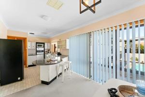 a kitchen with a large island in a room at Cheerful Beach house at Redhead - BBQ, Beach, Views in Redhead