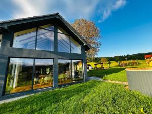a house with large windows on a lawn at Grosser Raw in Hamba