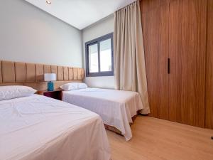 a hotel room with two beds and a window at Résidence Oscar - Pool & View in M'diq +14 photos