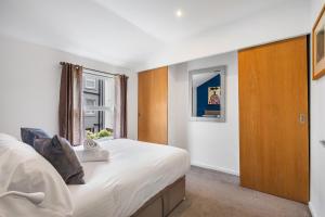 a bedroom with a large bed and a window at Leafy Haven By My Getaways in Brighton & Hove +20 photos