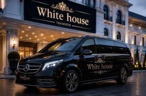 a black van parked in front of a building at Aziza Hotel White Tashkent in Yakkasaray