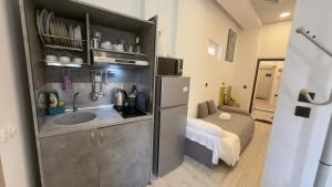 a small kitchen with a sink and a refrigerator at TRAVELLERS CORFU TOWN Luxury Suites, Studios & Apartments in Ágios Rókkos +112 photos