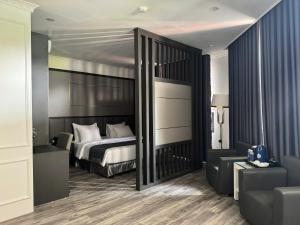 a bedroom with a large bed and a couch at Sen plaza Hotel in Yên Thành