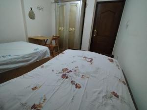 a bedroom with a bed with a blanket on it at Pink Horizon Homestay - for Men ONLY in Dumyāţ al Jadīdah