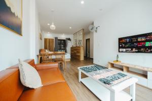 a living room with a couch and a table at BOHO Homestay No10 Alley 08 Ton That Thiep - Hanoi in Hanoi