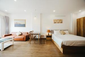a hotel room with a bed and a couch at BOHO Homestay No10 Alley 08 Ton That Thiep - Hanoi in Hanoi