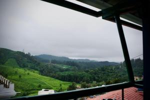 a view from a window of a mountain valley at Shabeer's White Castle in Ooty