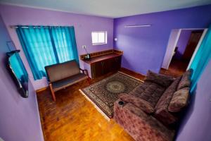 a living room with a couch and a desk at Shabeer's White Castle in Ooty +2 photos