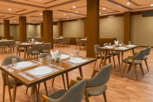 a dining room with tables and chairs in a room at Hotel The Fortune Luxury Rooms Near Mall Road Manali By Vistas - Best Selling Centrally Heated Property 2025-26 in Manāli