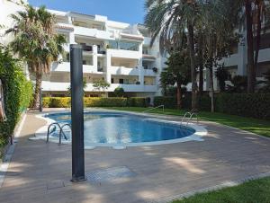 a swimming pool in front of a building at Appartement piscine Rosas in Roses