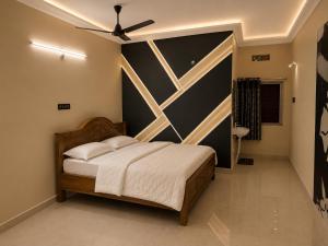 a bedroom with a bed and a ceiling fan at Winter Valley Grand Araku in Araku