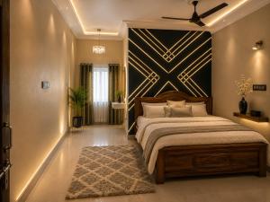 a bedroom with a bed with a black and gold wall at Winter Valley Grand Araku in Araku
