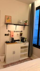 a kitchen with a white cabinet and a window at August in Jazan +10 photos
