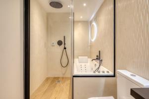 a bathroom with a shower and a toilet and a sink at Studios - Appartements Le Médicis in Rouen +66 photos