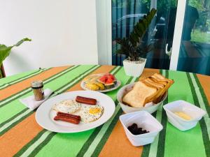 a table with two plates of breakfast food on it at Airport Kiyas Transit Villa Free Airport Pickup or Drop in Katunayaka