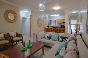 a living room with a couch and a table at Lakeview Cabanas - Unit 5 in St Lucia