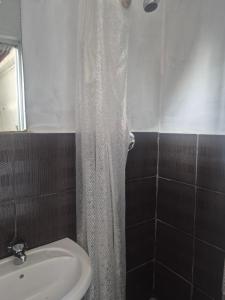 a bathroom with a shower curtain and a sink at Refresh & Recharge 721 in Durban