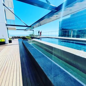 a swimming pool on the top of a building at Urban Elephant 16 On Bree in Cape Town