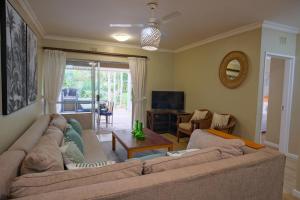 a living room with two couches and a television at Lakeview Cabanas - Unit 5 in St Lucia