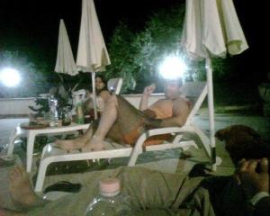 a group of people sitting in a pool at night at Terra Nostra in Cattolica Eraclea +18 photos