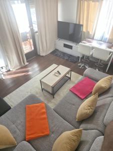 a living room with a couch and a television at HappyNest in Böblingen