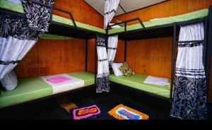 a room with two bunk beds in a house at The Travel Tree Hostel in Sigiriya