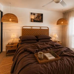 a bedroom with a large bed with a tray on it at Luxury Renovated Resort Studio Apartment - Oaks Pacific Blue in Salamander Bay +4 photos