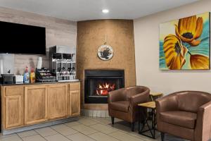 a lobby with a fireplace and two chairs at Baymont by Wyndham Santa Fe in Santa Fe