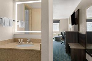 a hotel bathroom with a sink and a mirror at Baymont by Wyndham Santa Fe in Santa Fe +39 photos