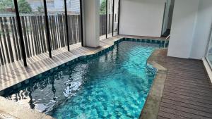 a swimming pool in the middle of a building at Azure Suite Apartment - AOSIS in Bagam