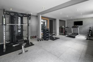 a room with a gym with weights and machines at Bali Hotel Adults Only Isla Verde, a Trademark by Wyndham in San Juan