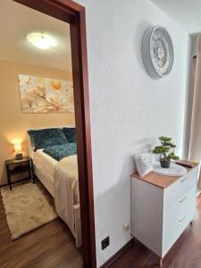 a bedroom with a bed and a table and a mirror at HappyNest in Böblingen