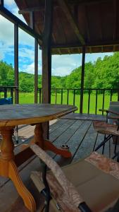 a wooden table and chairs on a screened in porch at Bears House in Furano
