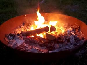 a pot full of fire with a stick in it at Bears House in Furano