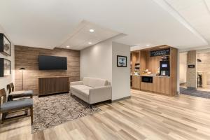 a lobby with a waiting room with a chair and a tv at Candlewood Suites Oak Harbor by IHG in Oak Harbor
