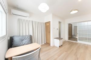 a living room with a table and a chair at JUJO Inn in Tokyo +131 photos