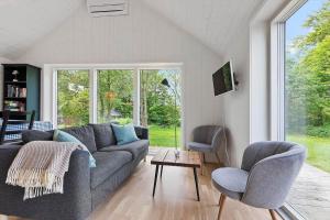 a living room with a couch and two chairs at 8574-Grenaa-Annavej-13 in Gjerrild