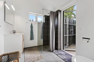 a bathroom with a shower and a glass door at 8574-Grenaa-Annavej-13 in Gjerrild +17 photos