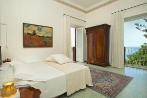 a white bedroom with a bed and a window at Romantic Hotel & Restaurant Villa Cheta Elite in Maratea +37 photos