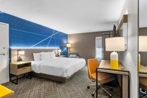 a hotel room with a bed and a desk at Comfort Inn Douglasville - Atlanta West in Douglasville +50 photos