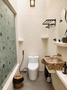 a bathroom with a toilet and a sink at Eve Evy Private Pool Villas in Nusa Lembongan +17 photos