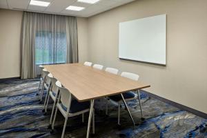 a conference room with a table and chairs and a whiteboard at Fairfield by Marriott Frankfort in Frankfort +23 photos