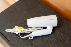 a white adapter sitting on top of a table at JUJO Inn in Tokyo