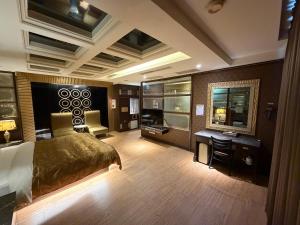 a hotel room with a bed and a desk at Venice Motel in Kaohsiung