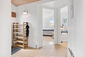 a hallway with a room with a bed and a room with a ladder at FY421-Frorup-Grantoften-3 in Frørup